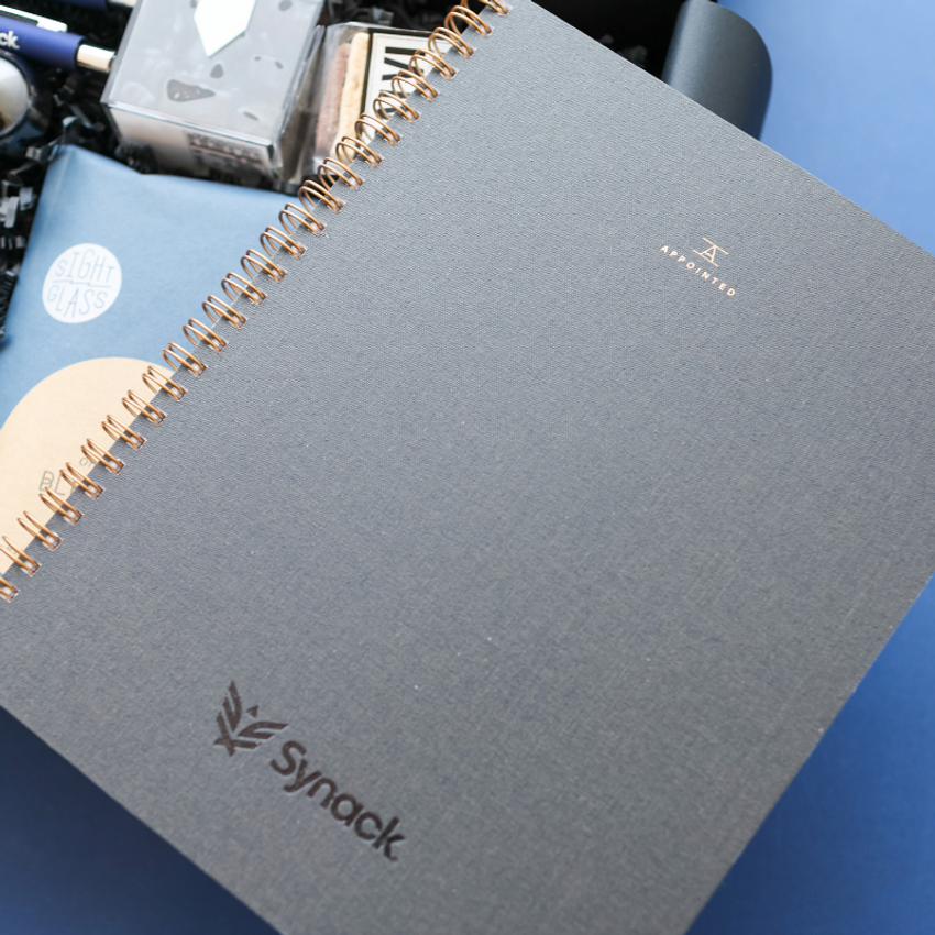 close up of branded notebook with company embossed logo