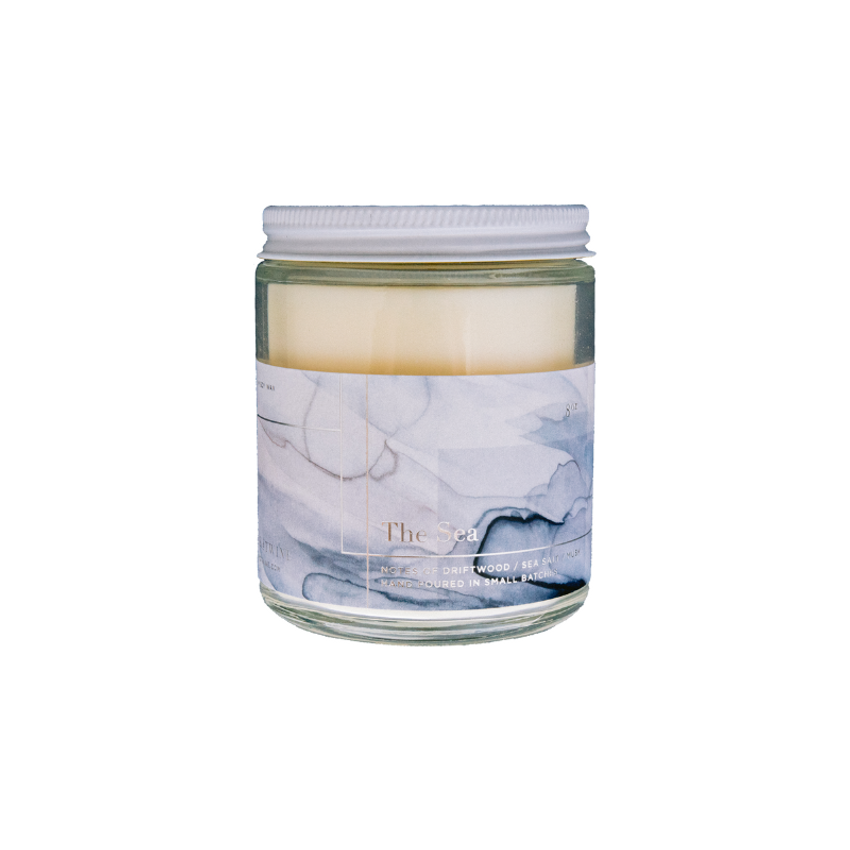 marble labeled vanilla candle white background