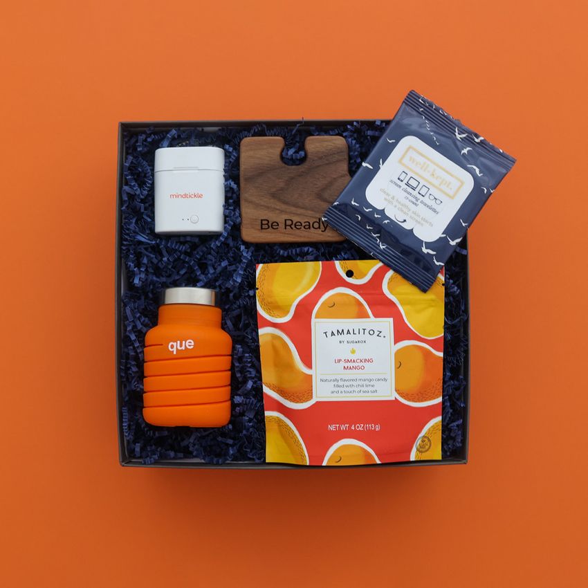 mindtickle brand gift box with ear bud case orange background