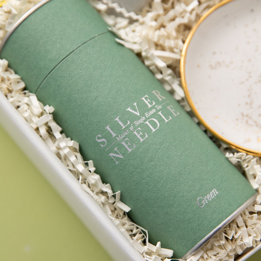 green tube of tea in gift box